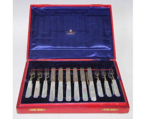 An Edwardian silver and mother of pearl dessert service, comprising twelve pairs of fruit knives and forks, James Dixon &amp;