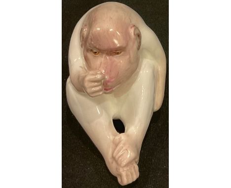 A Royal Worcester 'netsuke', of a white ape, seated, 7cm high, crown and circle mark in green, c.1910 
