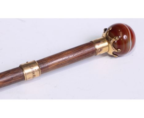 An early 20th century banded agate and gilt metal mounted walking stick, globular pommel, the ferule inscribed Edith H Lowry,