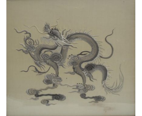 A Chinese silk panel, embroidered in relief with a dragon amongst clouds, 50cm x 54cm 