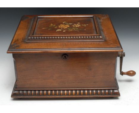 A 19th century walnut table-top symphonion, horizontal movement playing steel disks, hinged cover inlaid with flowers, monoch