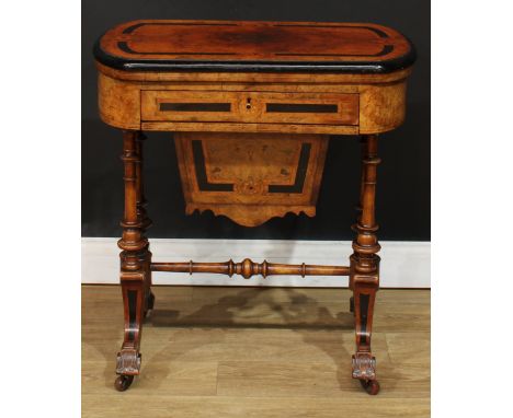 A Victorian walnut and parcel-ebonised combination games and work table, hinged quarter-veneered top enclosing parquetry fiel