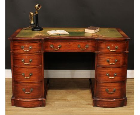 A late Victorian mahogany twin pedestal desk, slightly oversailing top with inset tooled and gilt writing surface above three