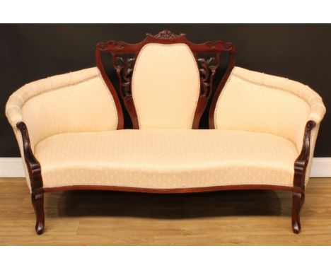 A late Victorian mahogany central-chair-back sofa, shaped cresting rail carved with acanthus, stuffed-over upholstery, serpen