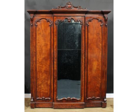 A Victorian mahogany breakfront wardrobe, by A. Blain, Liverpool, stamped, outswept cornice with shaped pediment carved with 