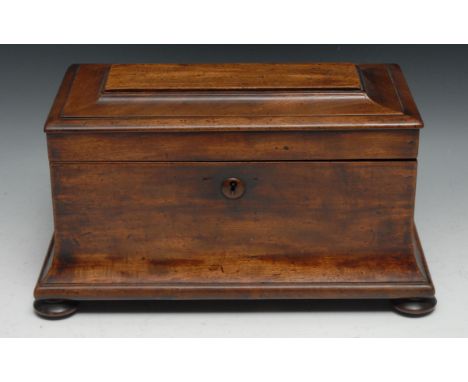 A large George/William IV mahogany concave rectangular tea caddy, hinged sarcophagus cover enclosing three compartments, skir