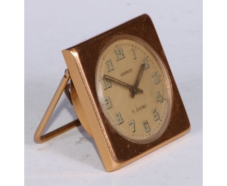 Hermes - a French gilt metal travelling easel timepiece, 5.5cm circular dial with luminous Arabic numerals, eight-day keyless