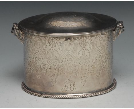 A Victorian Scottish silver oval tea caddy, hinged domed cover, cast lion mask handles, engraved with Gothic strapwork, 16cm 