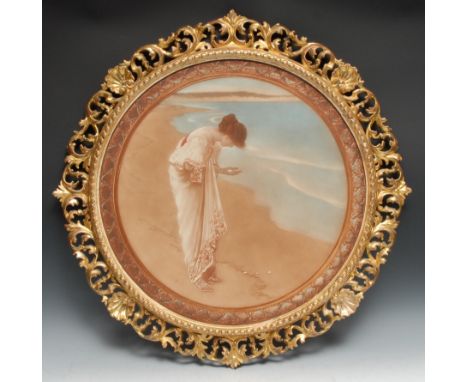 A 19th century giltwood shaped circular picture frame, containing a Pre-Raphaelite furnishing print, the border pierced and c