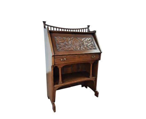 ARTS & CRAFTS OAK BUREAU, CIRCA 1900 with concave gallery above a foliate carved fall front, the interior fitted with pigeon 