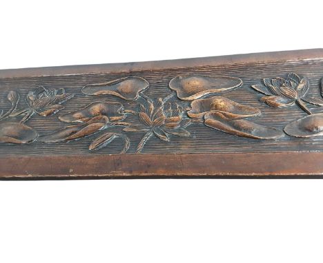 IN THE MANNER OF LIBERTY, ARTS & CRAFTS OAK LOW BENCH OR FOOT REST, CIRCA 1900 the oblong top carved with water lilies and pa