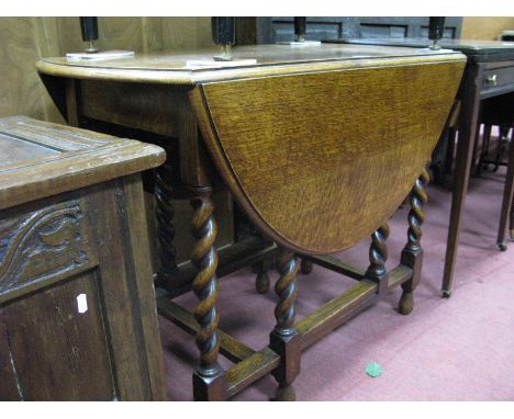 A 1920's Oak Gate Leg Table, on barley twist and block supports.