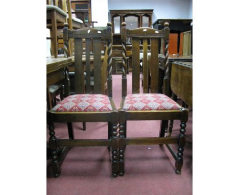 A Set of Four 1920's Oak Chairs, shaped top rail, rail supports, drop in seats, on bobbin and block supports.