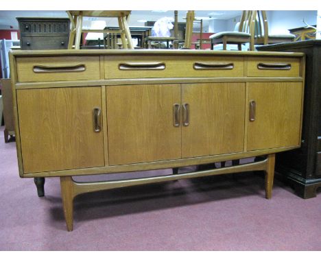 An Ercol Style Sideboard, with three top drawers, over cupboard doors, on tapering legs, with stretchers.