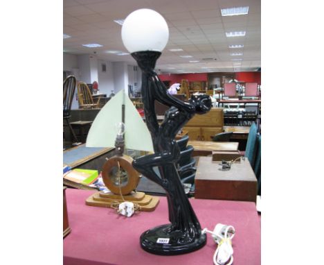 A Late XX Century Art Deco Style Lamp, featuring a black ceramic lady holding a white globe.