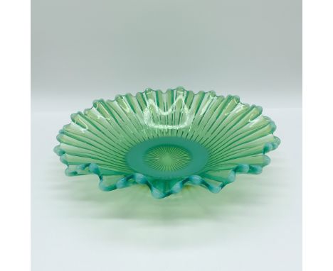 Elegant green opalescent glass bowl with a ruffled edge and ribbed design. The opalescence transitions beautifully from rich 