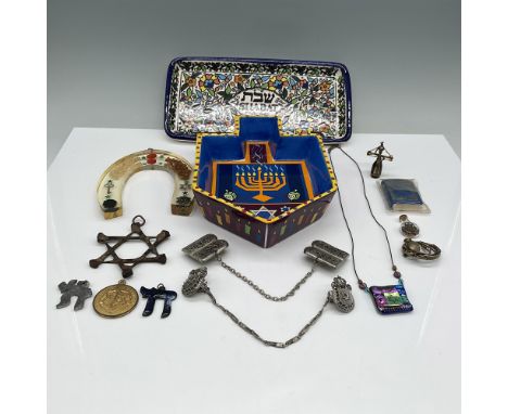 A diverse collection of Judaica and decorative items, including a hand-painted Armenian ceramic dreidel-shaped box and Shabba