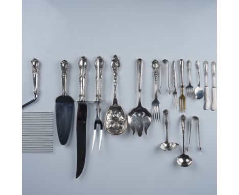 An assorted collection of sterling silver tableware from renowned manufacturers, showcasing a variety of elegant designs. Thi