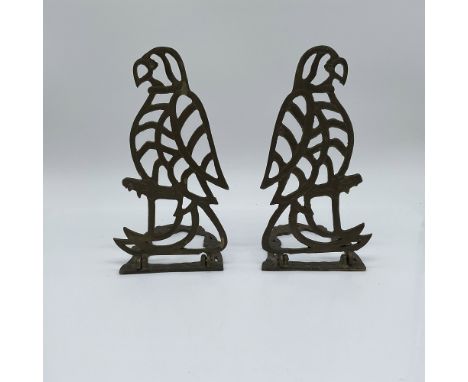 A finely crafted pair of vintage cast iron bookends featuring an intricate openwork design of falcons perched on branches. Th