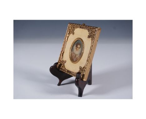 This antique miniature portrait features a finely detailed depiction of a regal woman dressed in an elaborate period costume,