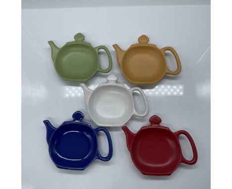 Set of five Chantal teapot-shaped ceramic spoon rests in vibrant colors: mustard yellow, green, blue, red, and white. Each me