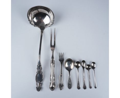 A diverse collection of American and English silver-plated and silver-inlaid dinner utensils from various manufacturers. This