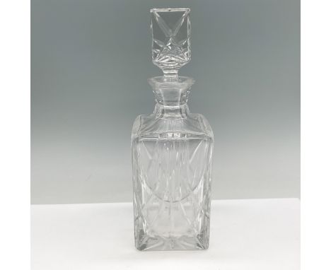 Elegant cut crystal decanter featuring a square form with intricate geometric patterns. The decanter boasts a faceted body wi