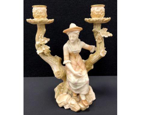A 19th Century Royal Worcester candlestick modelled as a young girl perched upon a twin-branched tree trunk, each branch term