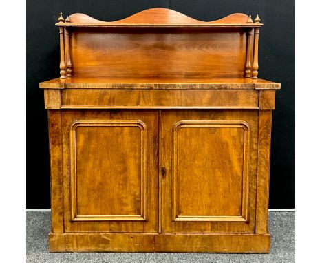 A William IV mahogany Chiffonier, the serpentine-shaped quarter galleried top with single shelf, and turned supports, above a
