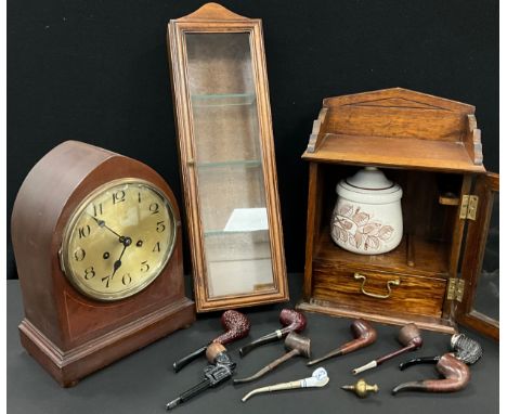 A German Junghans Wurttemberg oak mantel clock; Smokers cabinet containing various pipes including novelty pistol, wooden and
