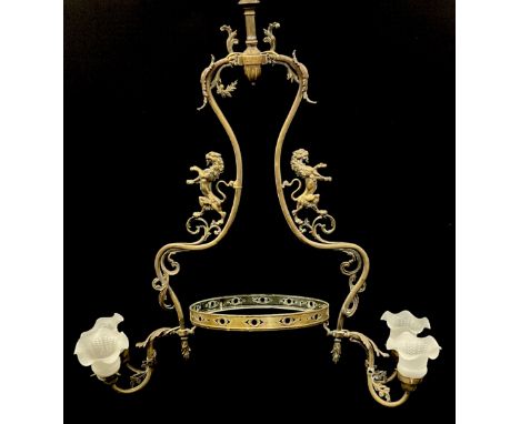 A large brass chandelier/light fitting, shaped scrolling arched body with Rearing Lion sides, above pierced circular shade ri