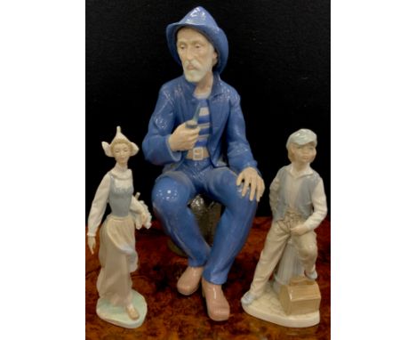 A large Nao figure as a Seated Fisherman smoking a pipe, impressed marks, 38cm high;  another Shoe Shine Boy, LLadro Dutch gi