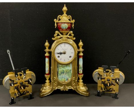 A modern gilt metal mantel clock, decorated in the french ornate style, embossed ceramic plaques and pillars depicting countr