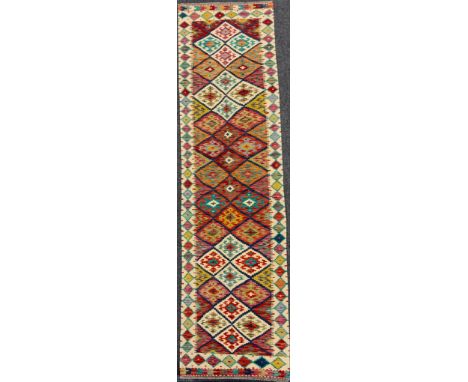 A Turkish Anatolian Kilim runner carpet, 305cm x 80cm.
