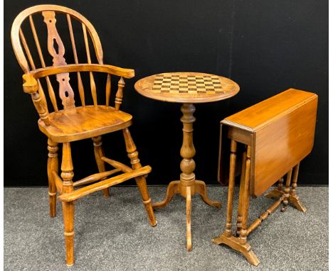 An early 20th century walnut tripod chess table, 70cm high x 45cm diameter;  a child’s Windsor type high chair;  small Suther