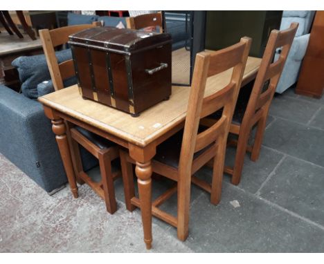 A modern oak dining table and 4 ladder back chairs 