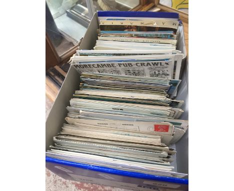 A box of various vintage postcards 