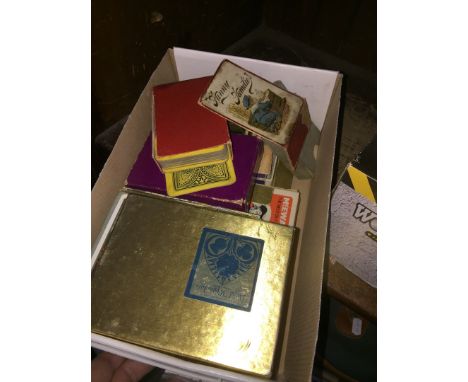 A box of vintage playing cards and a travelling chess set 