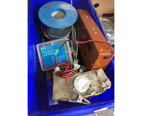 A box of misc tools to include a battery charger, oiler, etc 