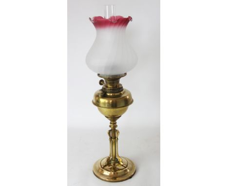 A late Victorian brass oil lamp, with later frosted glass shade, on column with Art Nouveau style mounts, 65cm
