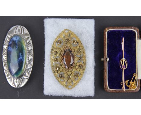 A garnet and seed pearl set bar brooch, all set in yellow gold stamped '9ct', with an attached safety chain along with an ova