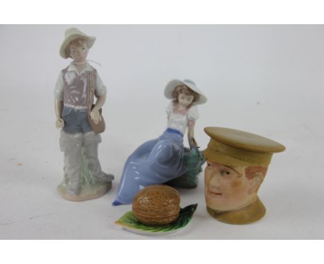 A bisque tobacco jar and cover modelled as a World War One officer; a porcelain ink well and cover modelled as a walnut on a 