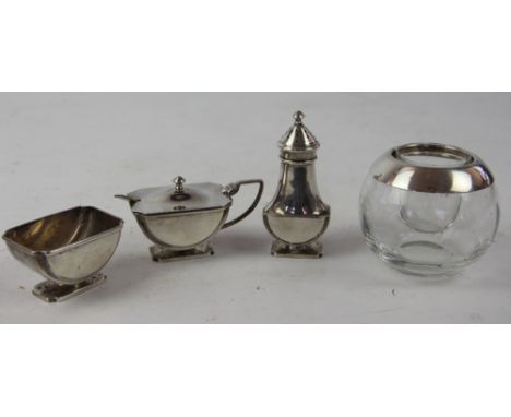 An Art Deco silver condiment set comprising open salt, pepper and covered mustard pot with spoon, Birmingham 1938; with a  co