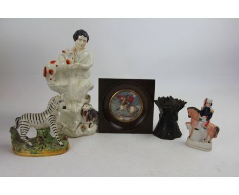 A portrait miniature of Napoleon on horse back, 7.5cm, with three pieces of Staffordshire pottery and Coalbrookdale style cas