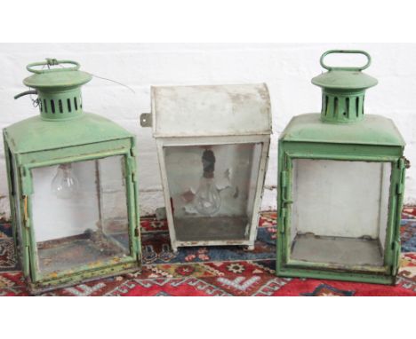 A pair of green painted cast iron lamps, of tapering form, 46cm x 36cm; with a white painted iron wall lamp, 52cm tall (3)