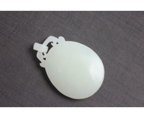 A Chinese white jade coloured stone pendant, of oval form, 4cm