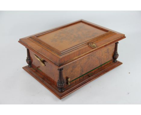 A late 19th century walnut Symphonium music box, playing 30cm discs on twin combs, the case lid decorated with birds on a bra
