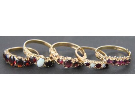 Six rings, to include; three garnet rings set in 9ct yellow gold, two opal and garnet rings and a Wedgwood blue jasper cameo 