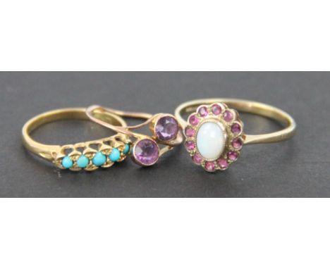 Three rings, to include; an opal and ruby oval cluster ring set in 9ct yellow gold, a two stone amethyst cross over ring and 