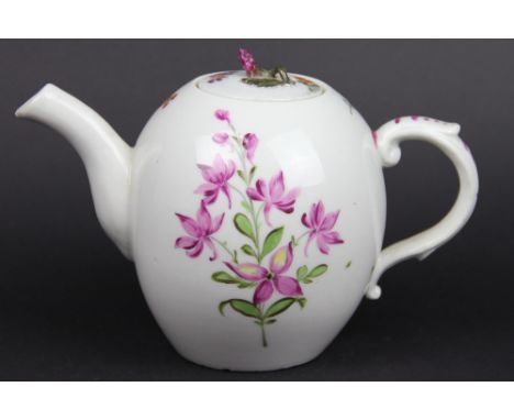 An 18th century Volkstedt porcelain teapot and cover, with flower bud finial and painted with floral sprays, moulded handle, 